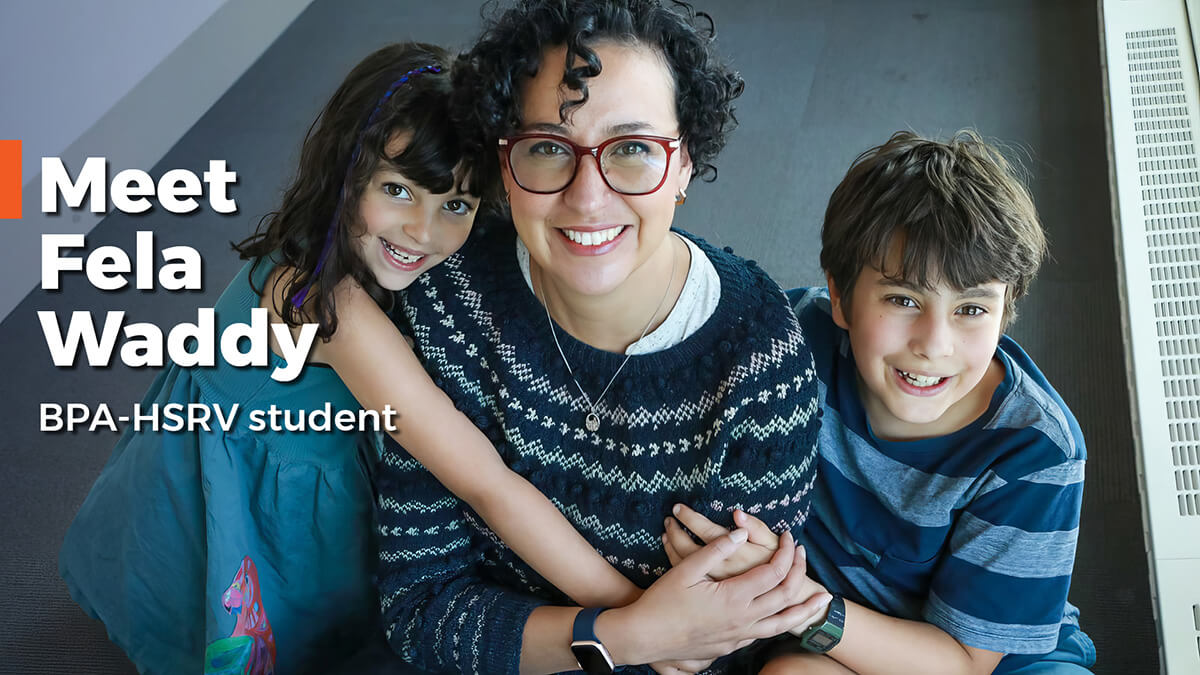 Fela Waddy sitting on the floor with her two kids.